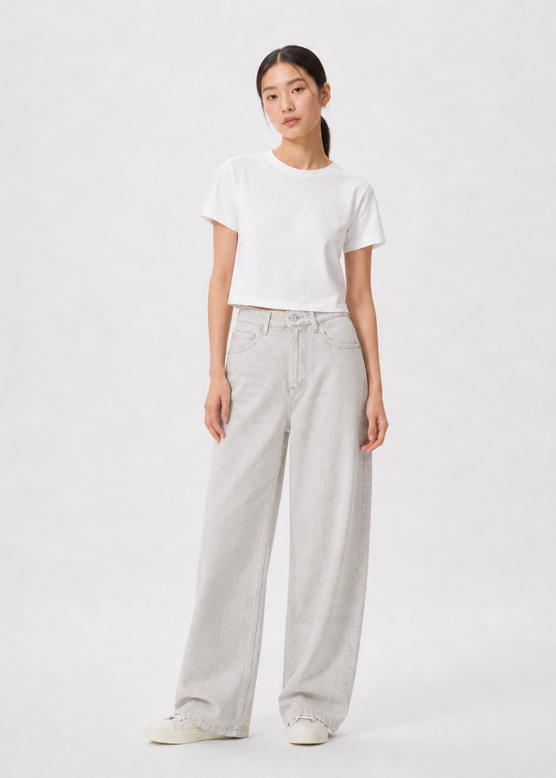 petite women wearing a white t-shirt and light gray petite jeans on a white background